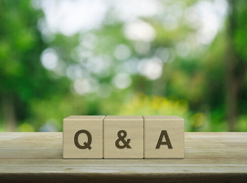 Q and A letter on block cubes on wooden table over blur green tree in park, Frequently asked questions, Business customer service and support concept
