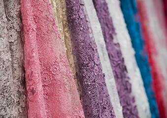 colorful fabric lace fabric rolls in textile shop industry.Rolls of bright colored fabric 