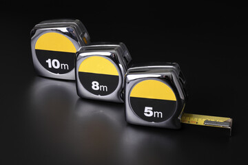 Flexometers or measuring tapes on black background