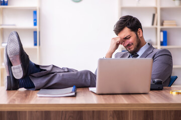 Young handsome businessman employee working in the office