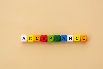 Acceptance text word, colorful wooden cubes. Inclusive and tolerance social concept, flat lay.