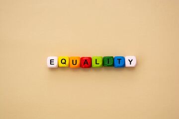 Equality word text made from colorful wooden cubes. Inclusive and tolerance social concept, top view