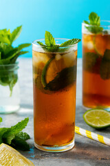 Cold tea, summer refreshing drink with mint leaves and lime.
