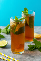Cold tea, summer refreshing drink with mint leaves and lime.