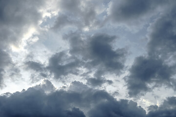 Dark sky full of clouds before the rain. Rain clouds and contrasting sunshine. Rain clouds.