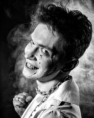 Black-and-white contrast portrait of an aggressive guy looking directly into the camera against a...