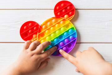 A child plays with a flapping fidget. popular children's flexible sensory toy develops fine motor skills, anti-stress, can be used for training with autistic people, popit toy