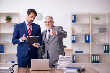 Two male employees working in the office