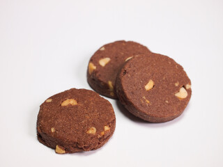 Homemade dark cookies on white background.
