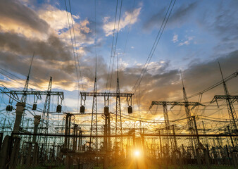 power line pylons during sunset with beautiful saturated sky. distribution transmission and...