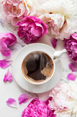 Pink peony flowers and cup of coffee