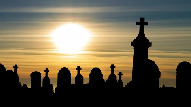 Tombstones in the cemetery at Sunset, Time Lapse with Colorful Clouds