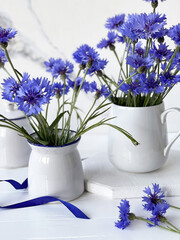 bouquet of cornflowers and white dishes