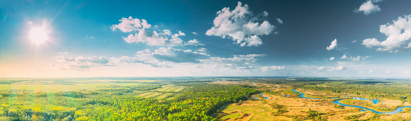 Aerial View Green Forest Woods And River Landscape In Sunny Summer Day. Top View Of Beautiful European Nature From High Attitude In Spring Season. Drone View. Bird's Eye View. Panorama