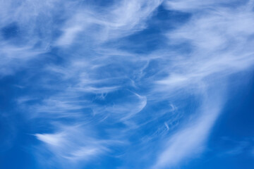 cirrus clouds,high in the sky flying plane in cirrus clouds, barely visible plane, cirrus clouds Fibratus