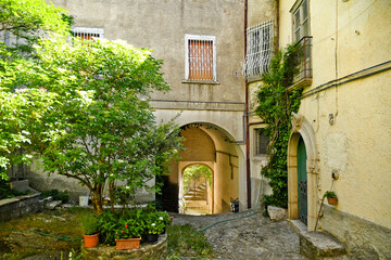 Fototapeta na wymiar San Fele, Italy, June 12, 2021. A narrow street among the old houses of a medieval village in the Basilicata region.