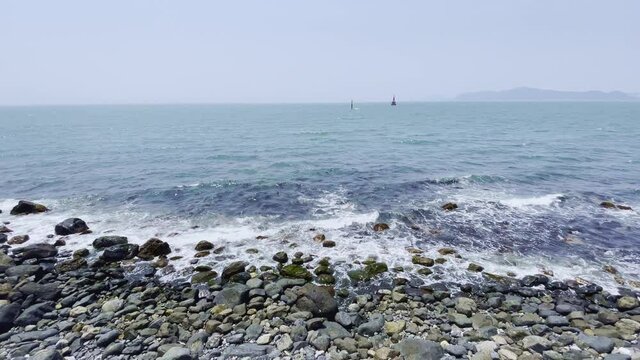 On the sandy beach, the waves constantly ring. blue sea and transparent sand landscape.