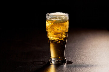 glass of beer on dark background