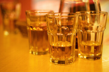 Three glasses with alcohol on the table in bar