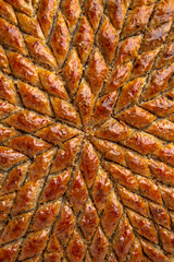 Obraz premium Turkish desert baklava with peanut, pistachio for holiday or ramadan. Traditional Middle Eastern Flavors. Selective focus, pattern.