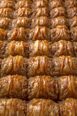 Turkish desert baklava with peanut, pistachio for holiday or ramadan. Traditional Middle Eastern Flavors. Selective focus, pattern.