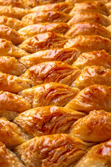 Turkish desert baklava with peanut, pistachio for holiday or ramadan. Traditional Middle Eastern Flavors. Selective focus, pattern.