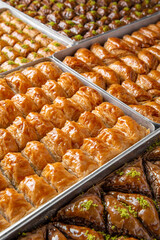 Turkish desert baklava with peanut, pistachio for holiday or ramadan. Traditional Middle Eastern Flavors. Selective focus, pattern.