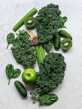 Healthy green smoothie or salad ingredients - superfoods, detox, alkaline diet, health or vegetarian food concept.