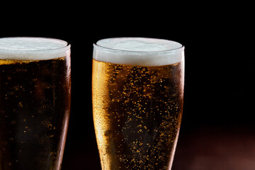 closeup glass of beer isolated on black