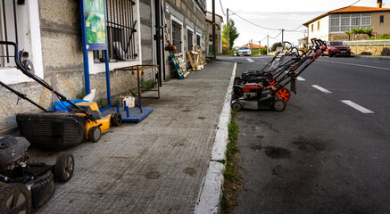 grass-cutting machines at the door of a repair shop