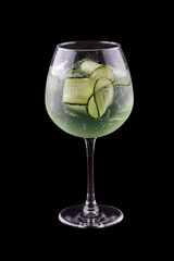 Martini cocktail, tonic and cucumber on a dark background. Isolated