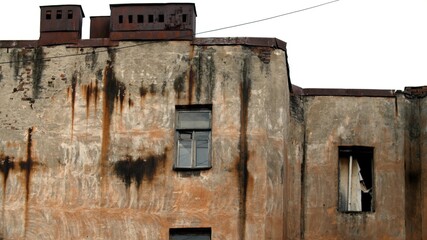 Abandoned scuffed dirty house, broken glass in the windows. House with broken windows. Weathered side of an old house in disrepair. 