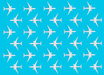 Creative pattern with toy airplanes on pastel blue background. Flat lay design  