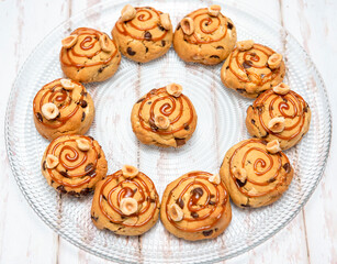 Chocolate cookies with chocolate chips and caramel on transparent plate. Image from above