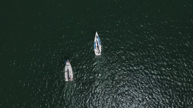 Sailboat sailing in high winds. Yacht racing at mediterranean sea. Aerial footage amazing.