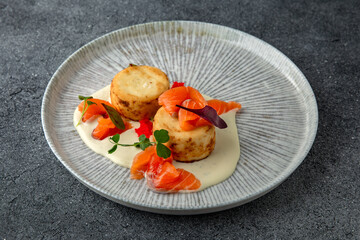 Lush cheesecakes with fresh pickled salmon and caviar. Healthy nutritious breakfast. Ready menu for the restaurant. Neutral gray blue textured background