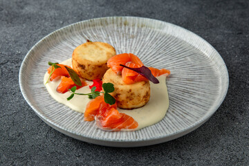 Lush cheesecakes with fresh pickled salmon and caviar. Healthy nutritious breakfast. Ready menu for the restaurant. Neutral gray blue textured background