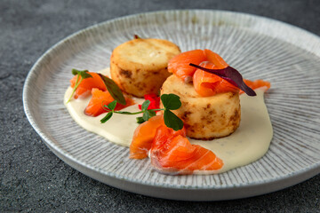 Lush cheesecakes with fresh pickled salmon and caviar. Healthy nutritious breakfast. Ready menu for the restaurant. Neutral gray blue textured background