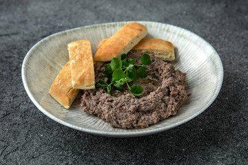 An appetizer made from red beans, vegetables and cheese. Toast pate. Healthy breakfast. Ready menu for the restaurant. Neutral gray blue textured background