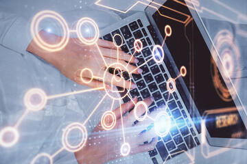 Double exposure of woman hands working on computer and social network theme hologram drawing. Top View. People connection concept.