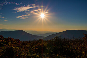 Glowing sun setting over the Blue Ridge Mountains