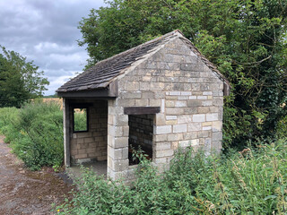 Fototapeta na wymiar old stone bus shelter