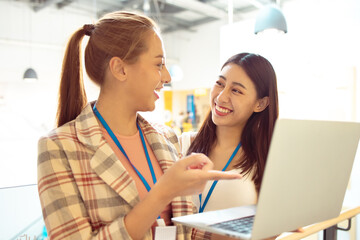 Portrait of Asian Woman Smiling Charmingly while Standing in walkway office. Portrait Of Successful Business Woman with laptop,startup small business concept in modern office.