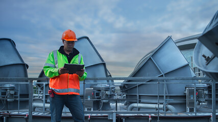 worker using  tablet on cooling tower plant .