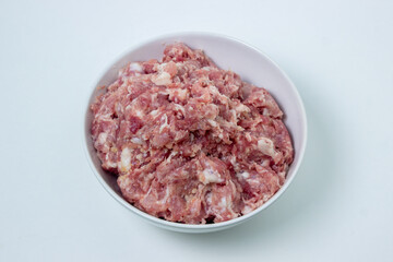 Fresh minced meat on a white plate. Minced pork meat.