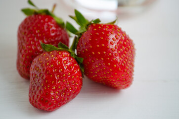 Ripe beautiful red strawberries on a white background.