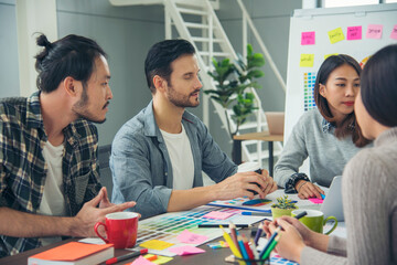 Fototapeta premium Creative design office center working teamwork. Happy business people partner plan strategy organization research people together at diversity office using laptop, smartphone company conference room