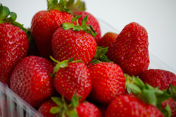 Ripe beautiful red strawberries on a white background.
