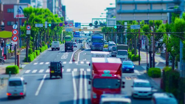 A timelapse of miniature traffic jam at the avenue daytime in the downtown tiltshift