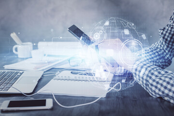 Double exposure of man's hands holding and using a phone and social network theme drawing.